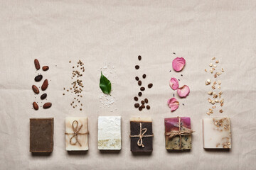 Natural soap bars with ingredients on linen cloth background. Diy cosmetics products