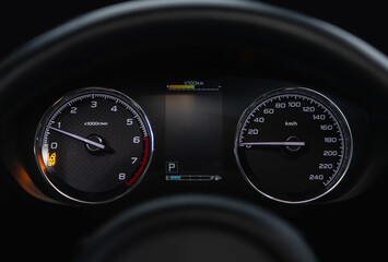 Fototapeta premium Speedometer, tachometer and steering wheel.speedometer of a modern car with an integrated fuel gauge in the tank with white arrows. .