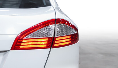 The back of a white expensive crossover car:  bumper, trunk lid, taillight on the back white...
