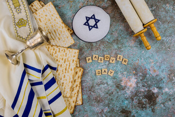 Pesach Passover symbols of great Jewish holiday traditional matzah, kippah and tallit, torah scroll
