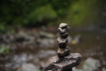 play rock balance in the river water flow. relaxation in the cool tropical wilderness. rock balance...