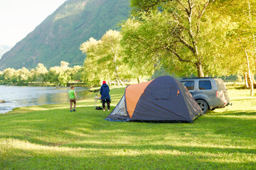 camping on the beach of river in the grove