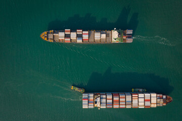 Fototapeta premium Aerial top view from drone, Container ship sailing on the green sea