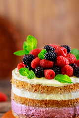 Naked sponge cake with vanilla cream and fresh berries.
