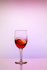 Glass of sweet red wine on white background.