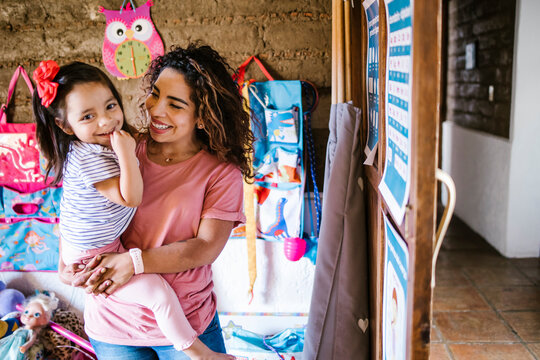 Mexican Mother And Her Daughter Child Girl Playing And Hugging