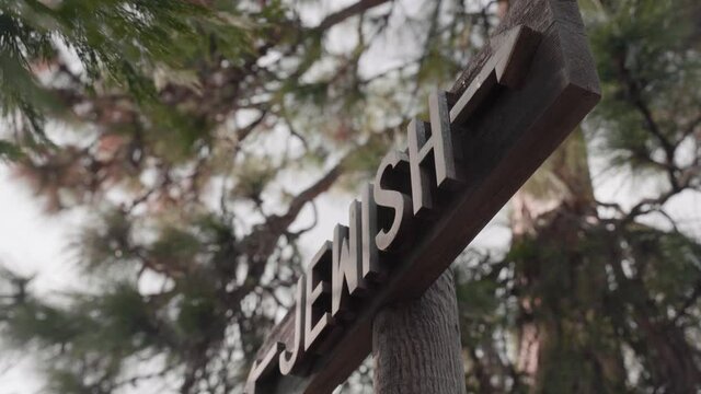 Jewish Cemetery Section Sign Surrounded by Trees