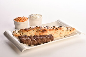 Arabic Traditional Ramadan , Kebab Roll Wrap , salad and hot pepper pickles on on a white background.