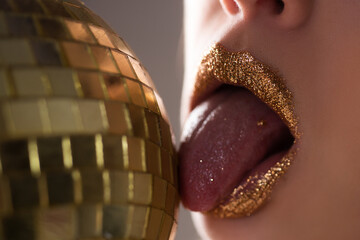 Sexy golden lips makeup. Seductive fashion gold metal lip. Beautiful make-up.