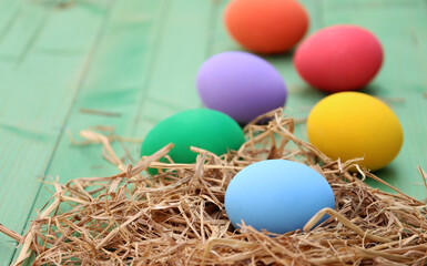 Fototapeta na wymiar easter basket with easter eggs on wooden background