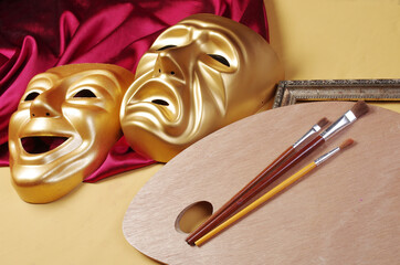 Attributes of the arts. Theatrical masks of tragedy and comedy, drapery, art palette, brushes.