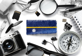Flag of Nauru and travel accessories on a white background.