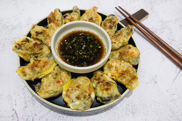 Korean food Oyster Pancake with Soy sauce.