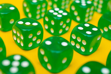 Green gaming dices pattern lines on yellow background. Table games concept background, board game for the whole family