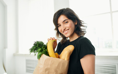 brunette in black t-shirts package with groceries shopping healthy food