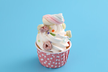 Colorful cupcake isolated in blue background