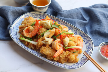 Stir fried Fish Maw with crabmeat and prawn - close up view on marble background ( Thai food called Kra Por Pla Pad Hang)