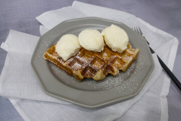 Freshly croissant waffle called croiffle. A plain croissant baked in waffle machine.