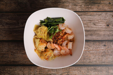 Shrimp dumpling with shrimp on wood background