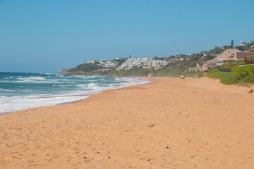 Golden Sandy Beach and Sea with Residential Buildings
