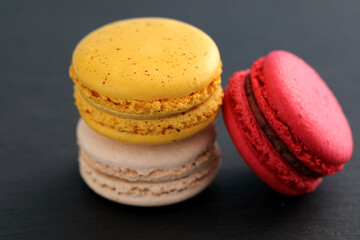 Colorful macarons isolated in black background