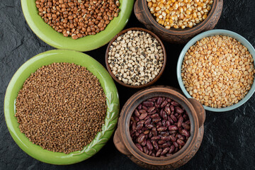 Different kinds of beans in colorful bowls