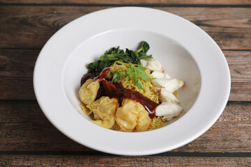Shrimp dumpling noodles and crab meat on wood background