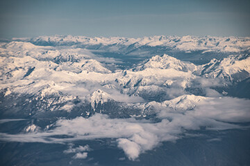 aerial view of clouds and snow cap mountains and lakes