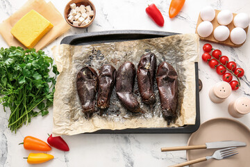 Tray of tasty baked eggplant on light background