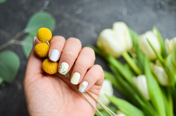 Women's hands with a colorful patterns on the nails. 2021 colors trend. Top view. A place for text. Spring nails concept.