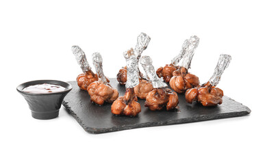 Plate with tasty chicken lollipops and sauce on white background