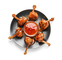 Plate with tasty chicken lollipops and sauce on white background © Pixel-Shot