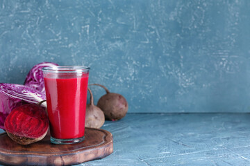 Glass of healthy smoothie with vegetables on color background
