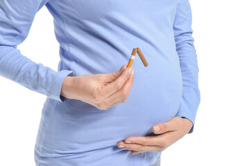 Young pregnant woman with broken cigarette on white background. Concept of refusing from bad habit