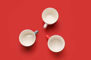 Empty cups on color background
