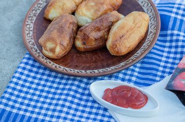 Homemade pastries with ketchup on a tablecloth