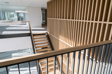 Naklejka premium This beautiful wooden staircase is located in the middle of a large building
