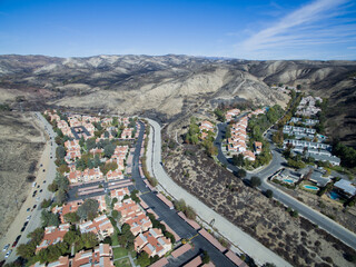 A charred hillside where a wildfire was stopped short of a neighborhood below