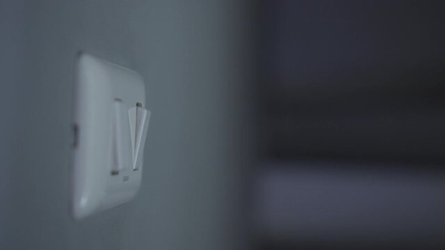 4K Close up hand push switch on-off electric light. Concept of energy and power saving.