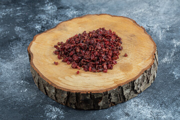 A wooden board full of dried cranberries