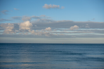 Landscape shot of ocean with boats seen in distance