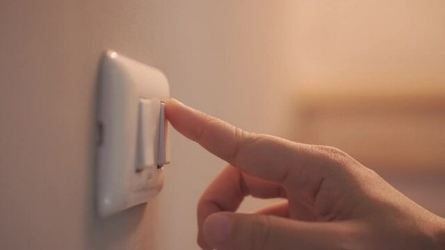 4K Close up hand push switch on-off electric light. Concept of energy and power saving.