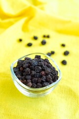 Dried Chokeberries on yellow background
