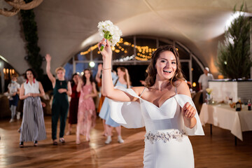 wedding tradition to throw a bouquet of bridesmaids. Fun. bride with long curls.