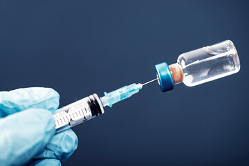 Covid-19 vaccination with vaccine bottle and syringe injection tool for coronavirus immunization...