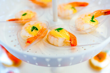 shrimp with sauce on Plastic spoon, appetizer 
