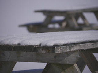 Two tables covered by snow