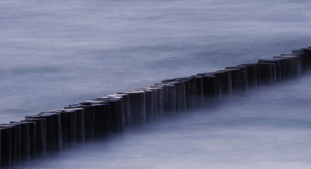 Groyne floated by waves at a beach
