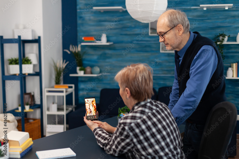 Poster senior couple talking with relatives during video call. happy grandparent communicating with family 