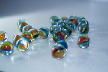 Colored balls on a white wooden background.